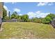 Expansive backyard with a well-maintained lawn, privacy fence, and mature trees at 6396 Bennett Ct, St Cloud, FL 34771