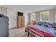 Bedroom features tile floors, two windows, and ample closet space with a tv atop a wood cabinet at 6396 Bennett Ct, St Cloud, FL 34771