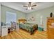 Cozy bedroom featuring a wooden bed frame, soft lighting, and wood flooring at 6396 Bennett Ct, St Cloud, FL 34771