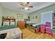 Shared bedroom featuring two beds with wood frames and decorative accents at 6396 Bennett Ct, St Cloud, FL 34771