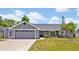 Charming single-story home with a two-car garage and a well-manicured lawn at 6396 Bennett Ct, St Cloud, FL 34771