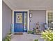 Close-up of a welcoming blue front door with decorative wreath and sidelight window at 6396 Bennett Ct, St Cloud, FL 34771