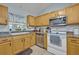 Well-equipped kitchen with wood cabinets, stainless steel appliances, and a bright window at 6396 Bennett Ct, St Cloud, FL 34771