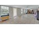 Spacious living room with tile flooring, multiple windows offering natural light, and ceiling fans for added comfort at 6396 Bennett Ct, St Cloud, FL 34771