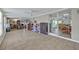 Open-concept living room with tile flooring, sliding glass doors, and versatile space for dining and entertaining at 6396 Bennett Ct, St Cloud, FL 34771