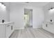 Well-lit bathroom featuring double sink vanities, modern lighting, and neutral wall colors at 7 Spring Pass, Ocala, FL 34472