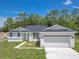 Charming single-story home with attached two-car garage and well-lit, inviting entryway at 7 Spring Pass, Ocala, FL 34472