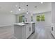 Bright kitchen featuring an island with a sink, stainless steel dishwasher, and sliding glass door at 7 Spring Pass, Ocala, FL 34472
