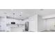 Modern, open-concept kitchen with white cabinets, stainless steel appliances, and a kitchen island at 7 Spring Pass, Ocala, FL 34472
