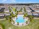 Aerial view of the community pool and lounge area surrounded by lush landscaping at 8897 Rhodes St, Kissimmee, FL 34747