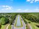 Aerial view of the water feature leading to community center bordered by lush trees and homes at 8897 Rhodes St, Kissimmee, FL 34747