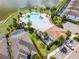 Aerial view of community pool, cabana, and residences with palm trees at 8897 Rhodes St, Kissimmee, FL 34747