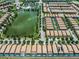 Aerial view showing community amenities, including a lake and community pool, near rows of private residences at 8897 Rhodes St, Kissimmee, FL 34747