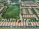 Aerial view of community and lake with fountain feature with location pin above one of many houses at 8897 Rhodes St, Kissimmee, FL 34747