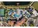 Aerial view of the community amenities, including a pool, lazy river, basketball court, and lake at 8897 Rhodes St, Kissimmee, FL 34747