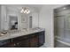 Beautiful bathroom with double sinks, granite countertops, and a glass-enclosed shower at 8897 Rhodes St, Kissimmee, FL 34747