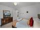 A well-lit bedroom with a TV, dresser, and a comfortable bed with decorative pillows at 8897 Rhodes St, Kissimmee, FL 34747