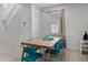 Bright dining room with a modern light fixture, stylish blue chairs and a large rustic wood table at 8897 Rhodes St, Kissimmee, FL 34747