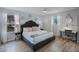 Serene main bedroom featuring a king-size bed, modern furniture, wood floors and a ceiling fan at 8897 Rhodes St, Kissimmee, FL 34747