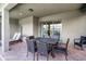 Covered patio boasts brick flooring and elegant outdoor dining set with seating for six near sliding glass door at 8897 Rhodes St, Kissimmee, FL 34747