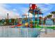 Community pool area with a fun splash pad featuring colorful slides and water features for all ages at 8897 Rhodes St, Kissimmee, FL 34747