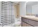 Neutral bathroom features a shower with tile surround, and dark vanity at 10 Pine Track Trl, Ocala, FL 34472