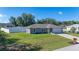 Well-maintained home featuring a fenced yard and long driveway leading to the attached garage at 10 Pine Track Trl, Ocala, FL 34472