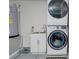 Laundry room features gray floor, and stacked washer and dryer at 10 Pine Track Trl, Ocala, FL 34472