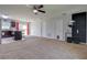 Spacious living room open to the kitchen features modern ceiling fan and neutral tones at 10 Pine Track Trl, Ocala, FL 34472