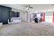 Spacious living room that flows into kitchen, features modern decor, carpet, and stainless steel appliances at 10 Pine Track Trl, Ocala, FL 34472