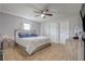 Main bedroom with ceiling fan, neutral carpet, and closet and ensuite bathroom at 10 Pine Track Trl, Ocala, FL 34472