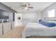 Well-lit main bedroom with plush carpet, ceiling fan, and en-suite bathroom at 10 Pine Track Trl, Ocala, FL 34472