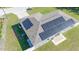 Aerial close up of roof with solar panels and showing the home's fenced in yard at 10 Pine Track Trl, Ocala, FL 34472