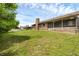 A long backyard with pool surrounded by trees. Has brick house in yard and sunroom at 1063 Fountainhead Dr, Deltona, FL 32725