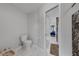 Bathroom featuring a standard white toilet and view of the walk-in shower with decorative accents at 1063 Fountainhead Dr, Deltona, FL 32725