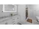 A well-lit bathroom with double sinks, a marble countertop, and a walk-in shower featuring stylish marble and stone at 1063 Fountainhead Dr, Deltona, FL 32725