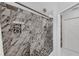 Stunning walk-in shower with marble-style tiles and unique decorative accents at 1063 Fountainhead Dr, Deltona, FL 32725