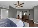 This is a primary bedroom with ensuite bathroom access, hardwood floors, gray walls, and a dresser with a mirror at 1063 Fountainhead Dr, Deltona, FL 32725