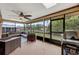 Inviting screened lanai features cozy seating and a ceiling fan for comfortable outdoor living at 1063 Fountainhead Dr, Deltona, FL 32725