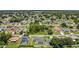 A broad aerial view showing the home nestled among other houses and mature trees in a suburban setting at 1118 Saint Tropez Ct, Kissimmee, FL 34759