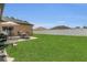 Lush backyard featuring a patio with dining set, barbecue, and privacy fence at 1118 Saint Tropez Ct, Kissimmee, FL 34759