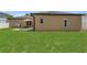 Large backyard with patio area, barbecue grill, and lush green grass at 1118 Saint Tropez Ct, Kissimmee, FL 34759