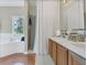 Bathroom featuring double sinks, a soaking tub, and a separate shower at 1118 Saint Tropez Ct, Kissimmee, FL 34759
