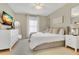Bright bedroom with a king bed, neutral décor, and large windows for natural light at 1118 Saint Tropez Ct, Kissimmee, FL 34759
