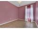 Pink bedroom featuring tiled floor, one window, neutral trim and paint at 1118 Saint Tropez Ct, Kissimmee, FL 34759