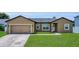Charming single-story home with a well-manicured lawn and a two-car garage at 1118 Saint Tropez Ct, Kissimmee, FL 34759