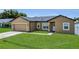 Charming one-story home with well-manicured lawn and attached two-car garage at 1118 Saint Tropez Ct, Kissimmee, FL 34759