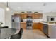 Well-equipped kitchen with stainless steel appliances and wooden cabinets at 1118 Saint Tropez Ct, Kissimmee, FL 34759