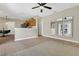 Open-concept living area featuring tile flooring, ceiling fan, and stylish mirrors at 1118 Saint Tropez Ct, Kissimmee, FL 34759