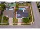 Aerial view of home with solar panels, a large pool, a red property line, and a well-kept yard at 12104 Shallot St, Orlando, FL 32837